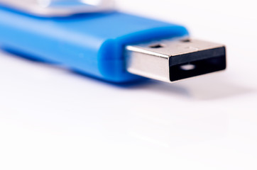 Detail of Usb flash drive on a white background. Flash drive is located in the corner of picture. Concept of technology. Isolated