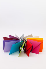 Different colored envelopes on the white desk