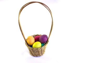 Basket with colorful easter eggs  on a white background