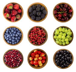 Collage of different fruits and berries isolated on white. Blueberries, cherries, blackberries, grapes, strawberries, currants. Collection of fruits and berries in a bowl. Top view.
