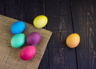 Easter eggs with sack on wooden desks