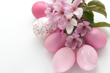 Easter. Greeting Card with pink colored Eggs and apple blossom on a white background. Resurrection...