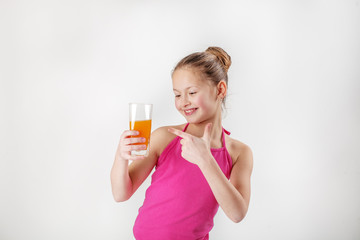 Child holds a glass of juice. The concept of healthy food and vitamins.
