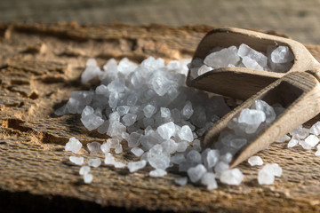 Cyprus sea salt flakes over bark on wooden background