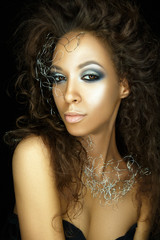 Beautiful woman portrait with glamour make up silver jewelry on neck.