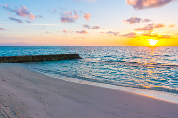 Beautiful sunset with sky over calm sea  in tropical Maldives island
