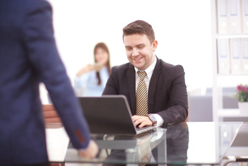 Happy smart business man with team mates discussing in the background