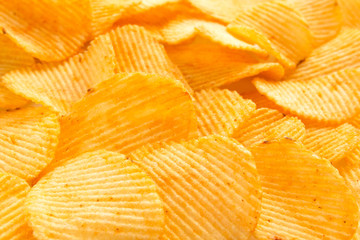 background corrugated delicious golden chips with texture close-up macro and sunlight