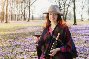 Young woman enjoying red wine outdoors