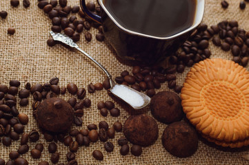 Hot coffee and sweets on the table, top view. Background.