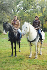Fototapeta na wymiar man and woman on horses