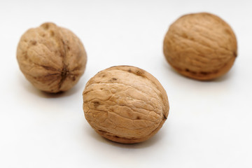 Three walnuts on a white background