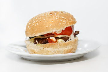 Isolated cheeseburger on a plate