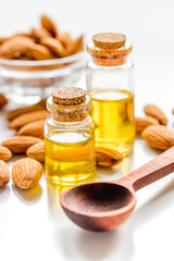natural oil and almond in cosmetic set on table background