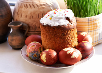 still life with easter cake, easter eggs and green grass