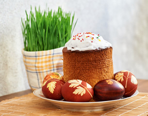 still life with easter cake, easter eggs and green grass