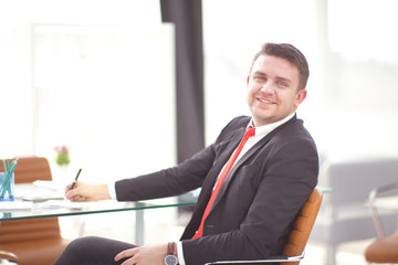 Successful businessman whith documents posing and smiling at camera