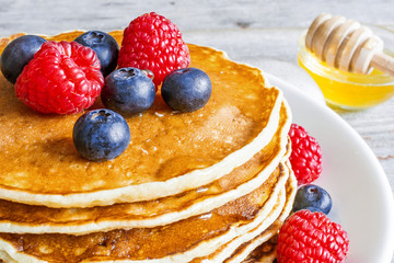 homemade pancakes with fresh berries and honey