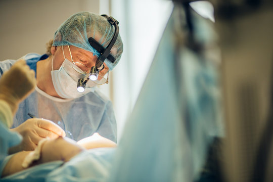 Stitching the patient's skin, the self-extracting threads, after surgery. breast augmentation, mammoplasty