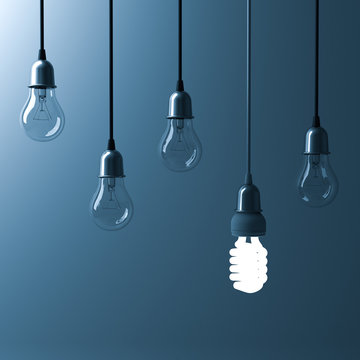 One hanging energy saving light bulb glowing different stand out from unlit incandescent bulbs with reflection on dark cyan background , leadership and different creative idea concept. 3D rendering.