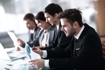 A group of successful businessmen. Discussion of the important contract of the company.
