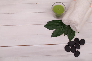 Spa still life with aromatic candles, orchid flower and stones