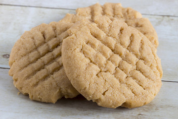 Homemade peanut butter cookies on light wood background
