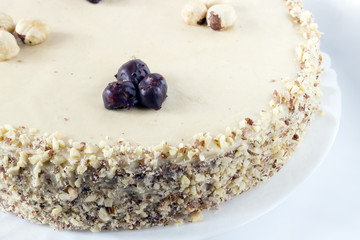 Homemade coffee hazelnut cake on white background