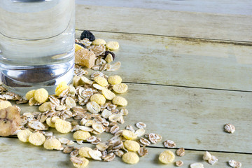 Foods for healthy eating: cereal, pure water on light wood background