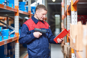 worker with laser barcode scanner at warehouse