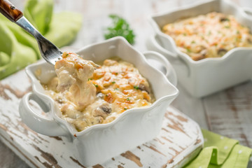 Baked gratin casserole chicken with mushrooms with cheese