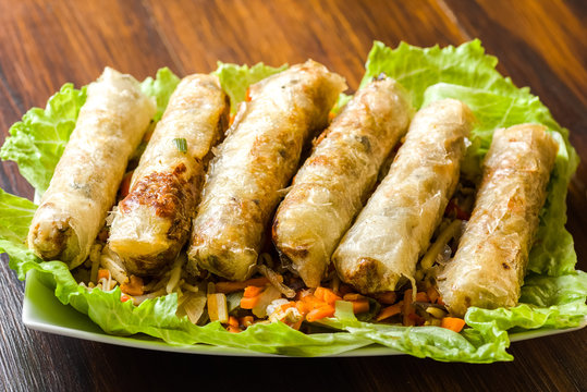 Spring rolls surrounded by vegetables