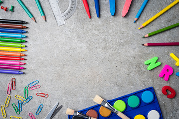 School supplies on gray stone background