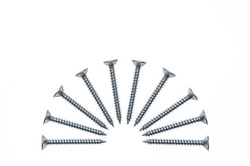 steel screws arranged in semi-circle on white background