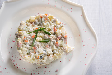 Vegetable salad with green peas and herbs on white plate