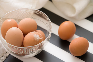 Fresh light brown organic eggs in a cristal bowl ready for Easter.