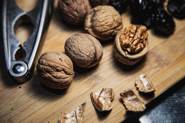 Walnuts nad dried prune on the wooden board for men's health