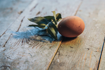 Easter farm eggs on rustic wooden table. Angle view.