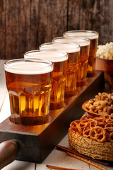 Beer row and snacks on wooden background football fan set