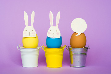 Easter eggs In rabbit masks in colored buckets, selective focus image, Card Happy Easter 