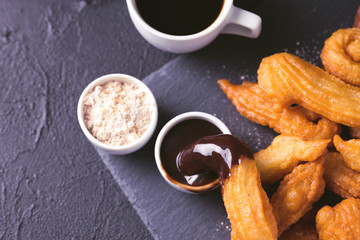 Traditional Spanish dessert churros with hot chocolate and coffee