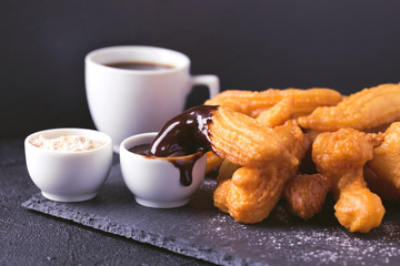 Traditional Spanish dessert churros with hot chocolate and coffee