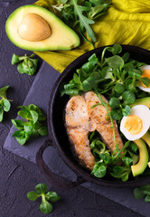 Grilled sheatfish fish steak with avocado, arugula and salad