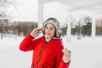 The girl walks in the snow-covered park. She rejoices to a winter time. On her face the fine smile shines. This girl forces us to smile and feel this magnificent winter mood too.