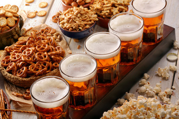 Beer row and snacks on wooden background football fan set