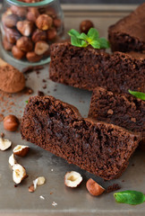 Homemade chocolate brownies with nuts on a metal, grunge background