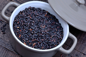 Black rice in a pot on table