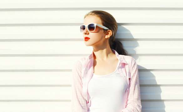 Fashion Portrait Young Woman In Sunglasses Looks Away Over White Background