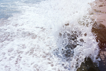 strong sea wave splashing on the beach shore