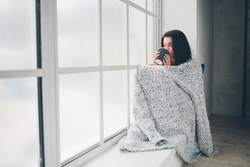 Young girl drinks delicious utensils of the coffe and thinks about plans for the day